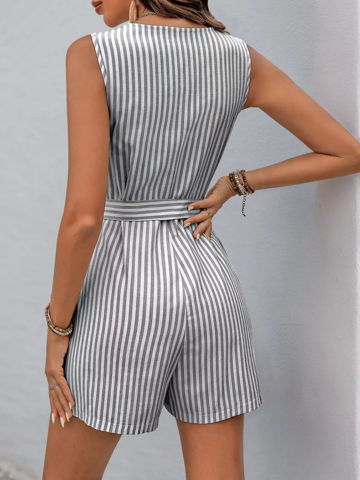 Back view of a striped V-neck belted romper, showcasing a chic design and tailored fit, ideal for stylish summer wear.
