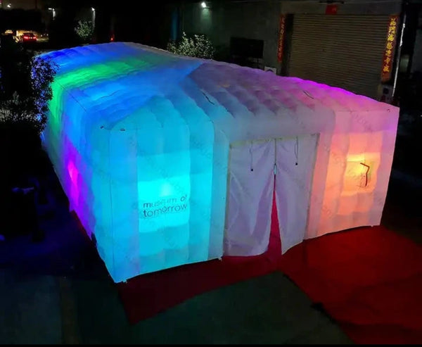 a lit up tent sitting on top of a red carpet