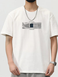 Men's white short sleeve t-shirt with graphic print and chain necklace, casual streetwear style.