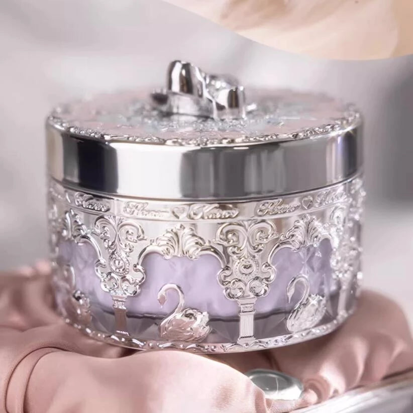 a woman's hand is holding a silver box