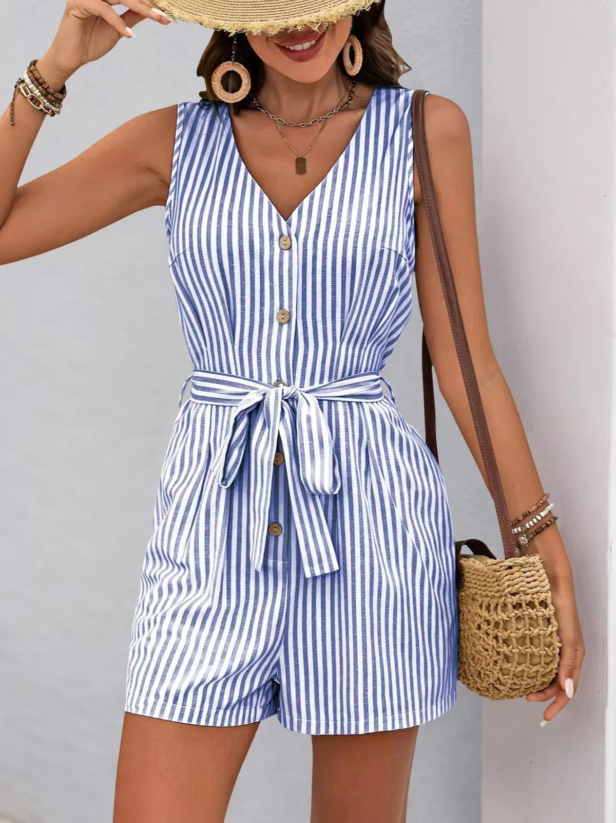 Striped V-neck button front belted romper in blue and white, showcasing a stylish silhouette with pockets.