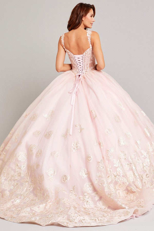 a woman in a pink ball gown with a bow on the back