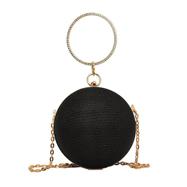 Spherical black handbag with a diamond ring handle and chain, perfect for luxurious weddings and elegant occasions.