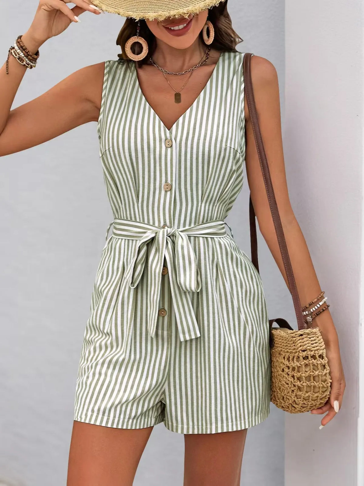 Striped V-neck button front belted romper, stylish summer outfit with practical pockets and tailored fit.