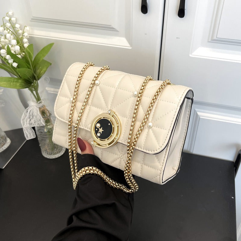 Elegant white leather crossbody bag with gold chain, perfect for luxurious weddings and sophisticated events.