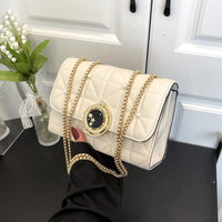 Elegant white leather crossbody bag with gold chain, perfect for luxurious weddings and sophisticated events.