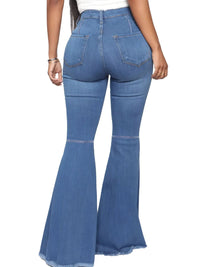 Back view of full size high-waisted raw hem flare jeans plus size in blue denim with slight stretch.