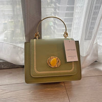 Stylish green leather mini crossbody bag with a gold handle and decorative clasp, perfect for luxurious weddings.