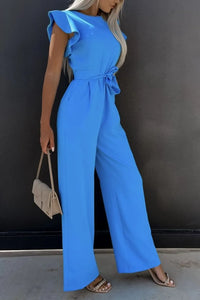 Model wearing a blue round neck cap sleeve jumpsuit with a tied waist, showcasing a stylish summer outfit.