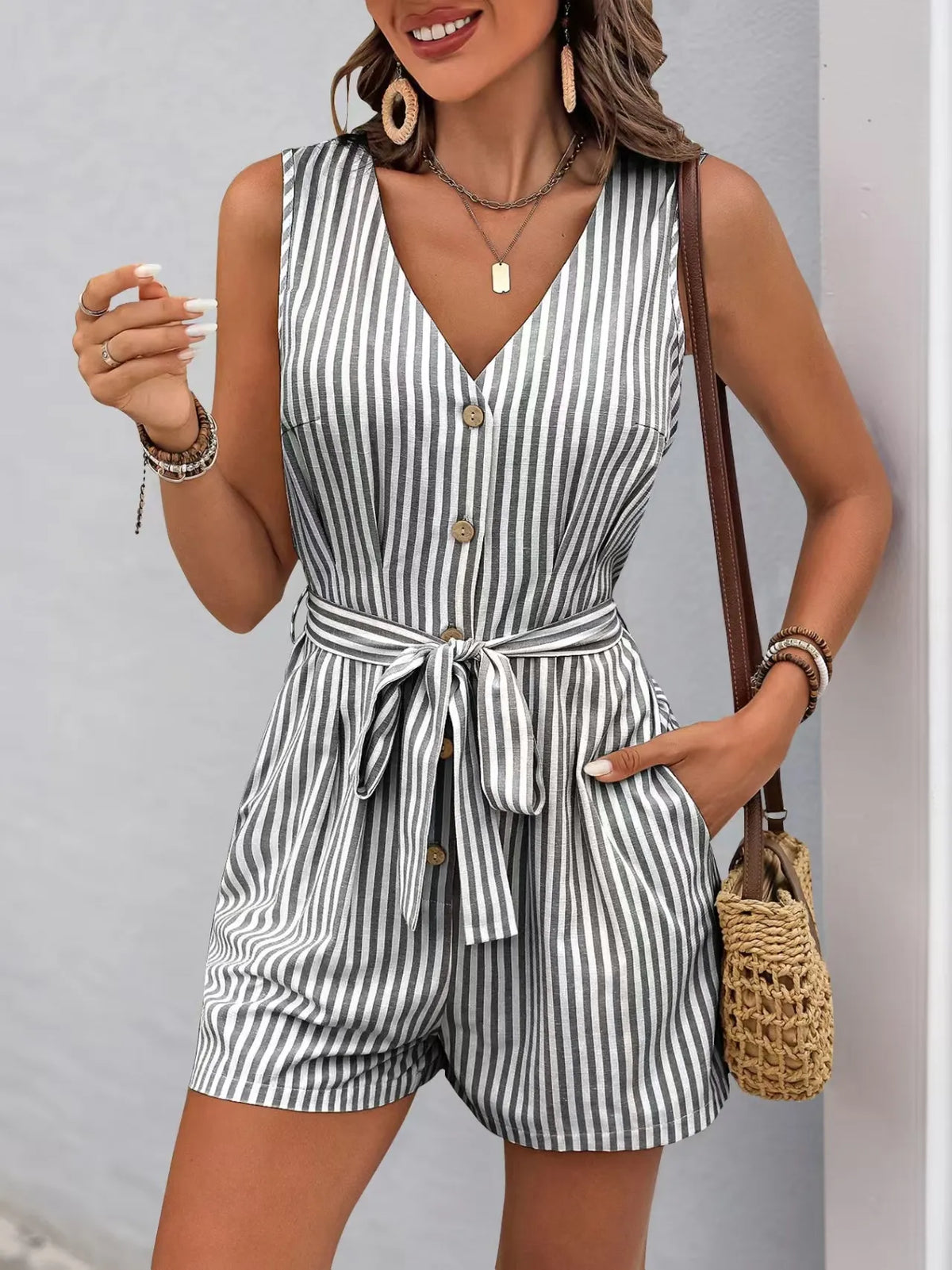 Striped V-neck button front belted romper with pockets, perfect for casual elegance and all-day comfort.