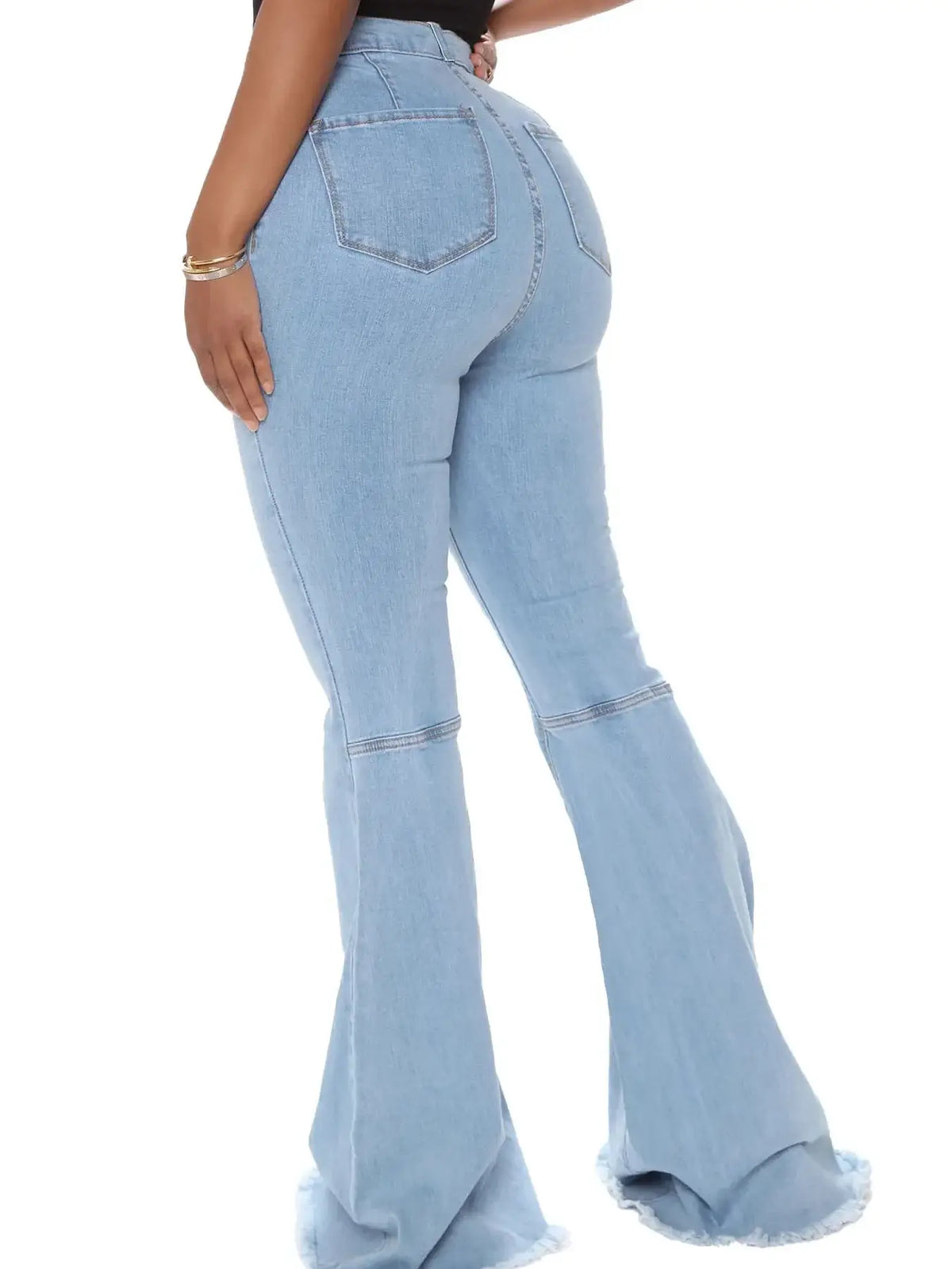 Model wearing plus size high-waisted raw hem flare jeans in light blue, showcasing back view with stylish fit.