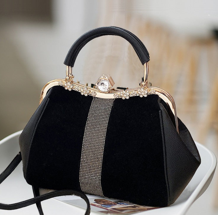 Luxurious women's handheld diamond bag featuring elegant black design, gold accents, and stylish embellishments.