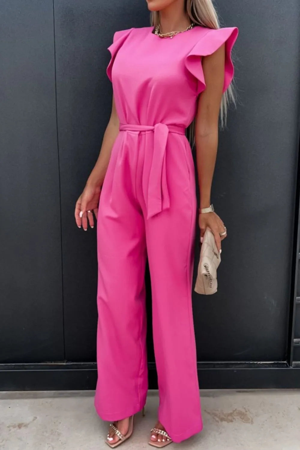Stylish pink round neck cap sleeve jumpsuit with belt, perfect for casual or formal occasions.