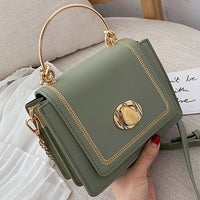 Stylish green leather mini crossbody bag with gold hardware, perfect for luxurious weddings and everyday elegance.
