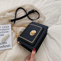 Luxurious leather mini crossbody bag for women in black with gold accents, perfect for weddings and stylish outings.
