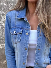 Full size button front long sleeve denim jacket featuring a light wash and chest pockets, perfect for casual wear.