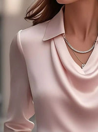 Ruched Long Sleeve Drape Collar Blouse in soft pink with drape collar detailing and necklace, perfect for elegant styling.
