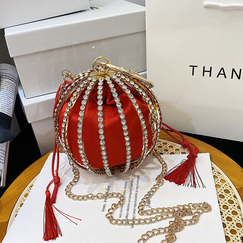 Luxurious diamond pearl flower metal ball handbag in red with gold accents, perfect for elegant weddings.