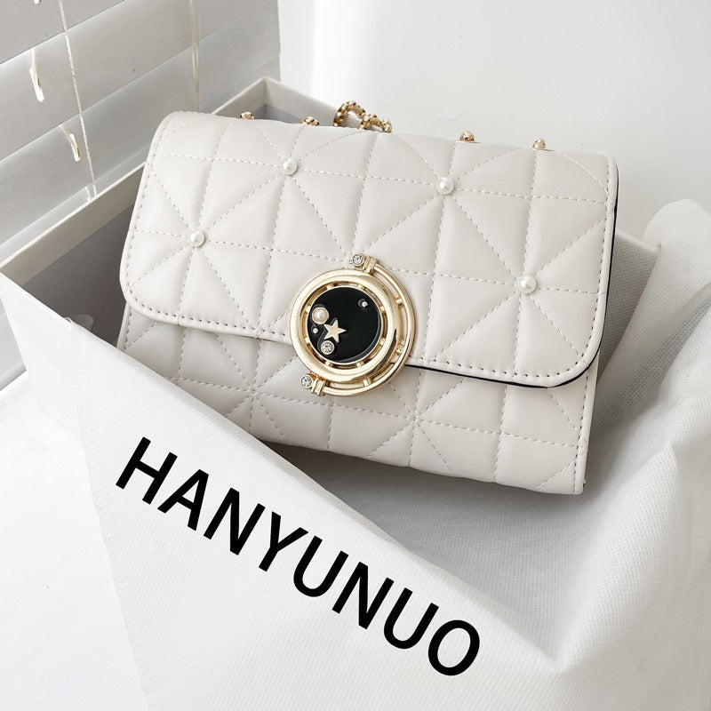 Luxurious white quilted crossbody bag with gold embellishment, perfect for weddings and special occasions.