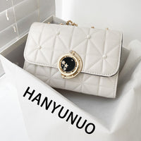 Luxurious white quilted crossbody bag with gold embellishment, perfect for weddings and special occasions.