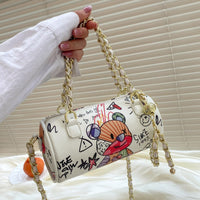 Graffiti cylindrical leather zipper crossbody bag in cartoon style, perfect for luxurious weddings.