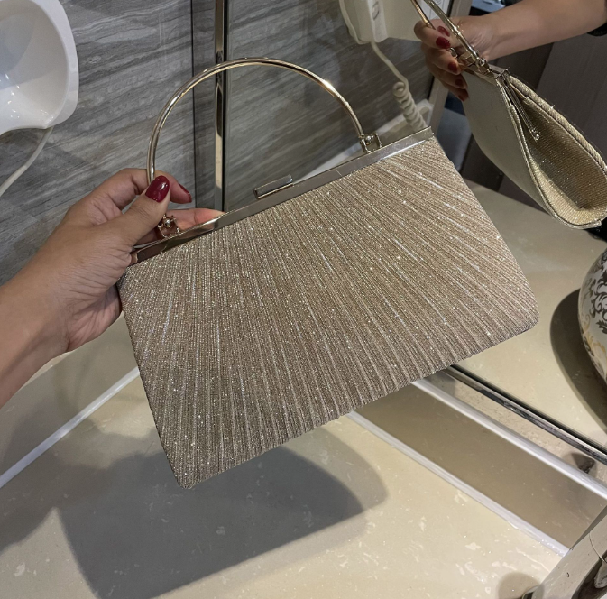 Elegant pleated shiny evening bag handbag in gold, perfect for luxurious weddings and special occasions.