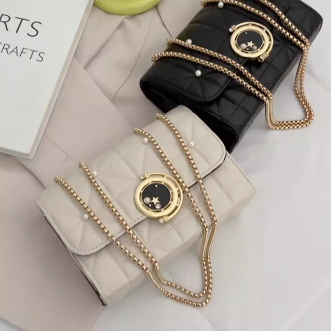 Elegant women's crossbody bags in black and white leather with decorative chains, perfect for luxurious weddings.