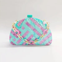 Half room geometric pearl acrylic box clutch in teal and pink, ideal for luxurious weddings.
