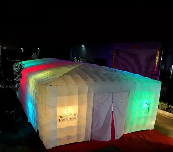 a lit up tent in the middle of a street