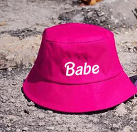 Hot pink bucket hat with 'Babe' text, perfect for bachelorette parties and celebrations.