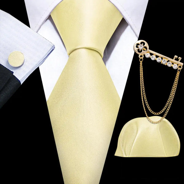 a gold tie and a white shirt with a gold chain attached to it