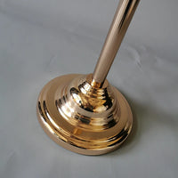 a golden metal object on a white surface
