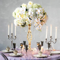 a table topped with a vase filled with white flowers