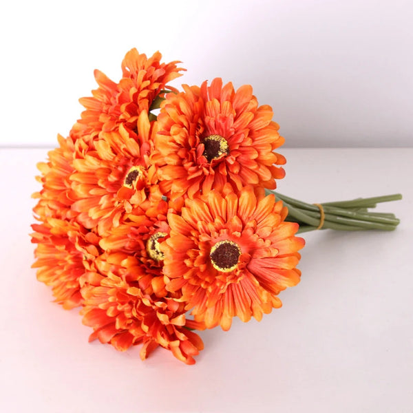 a bouquet of orange flowers sitting on top of a table