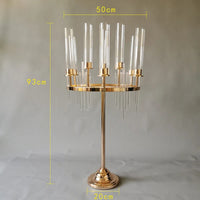 a brass candle holder with clear glass candles