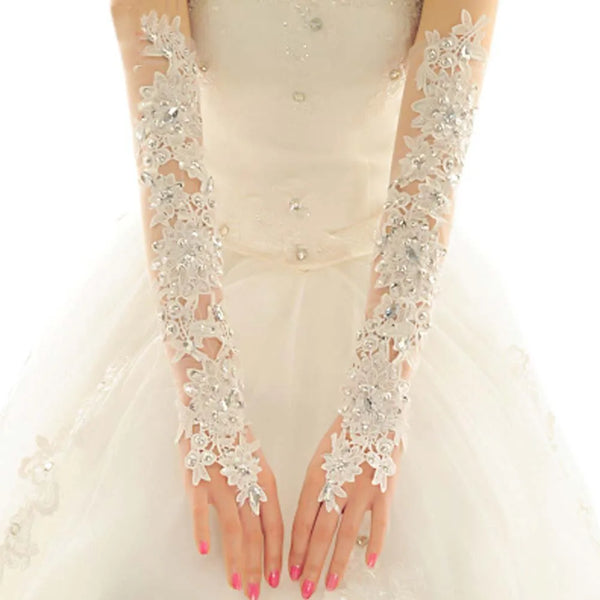 a woman in a white wedding dress wearing gloves