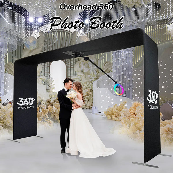 a bride and groom standing under a photo booth