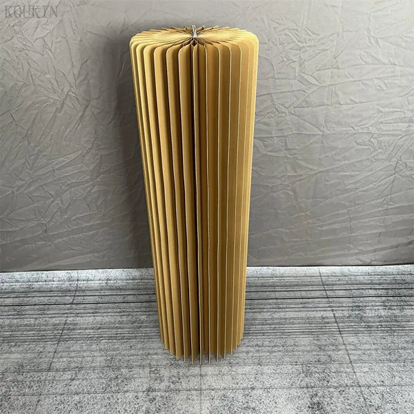 a tall yellow vase sitting on top of a floor