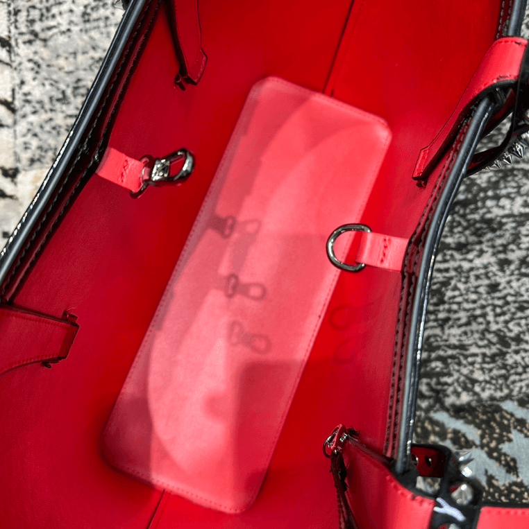 Interior of the Celestial Edge Handbag with vibrant red lining and hooks for organization