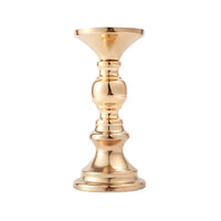 a golden candle holder on a white background