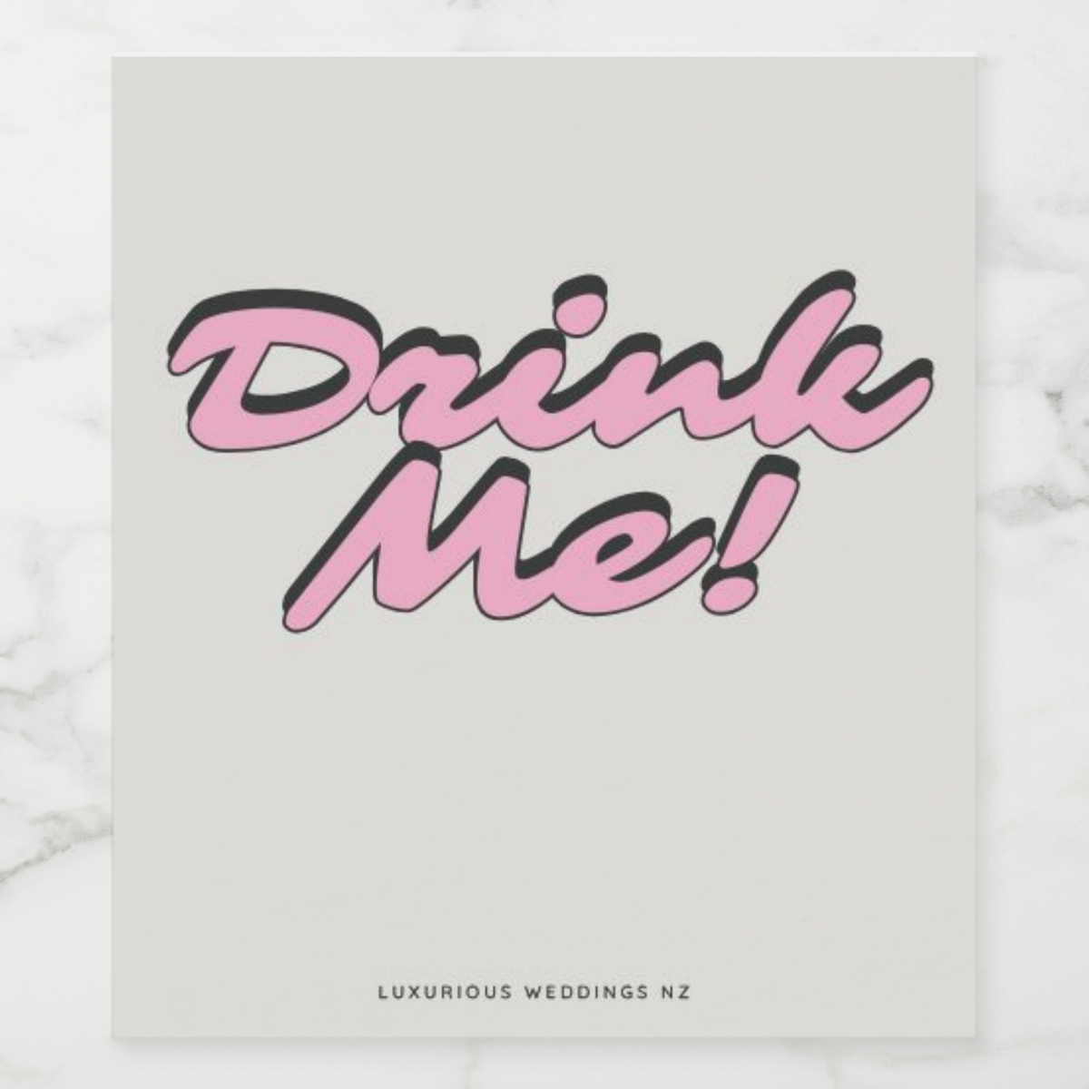 Bachelorette wine label design featuring playful text 'Drink Me!' in pink on a neutral background.