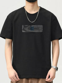 Men's black short sleeve t-shirt with graphic design on the front, featuring a round neck and relaxed fit.