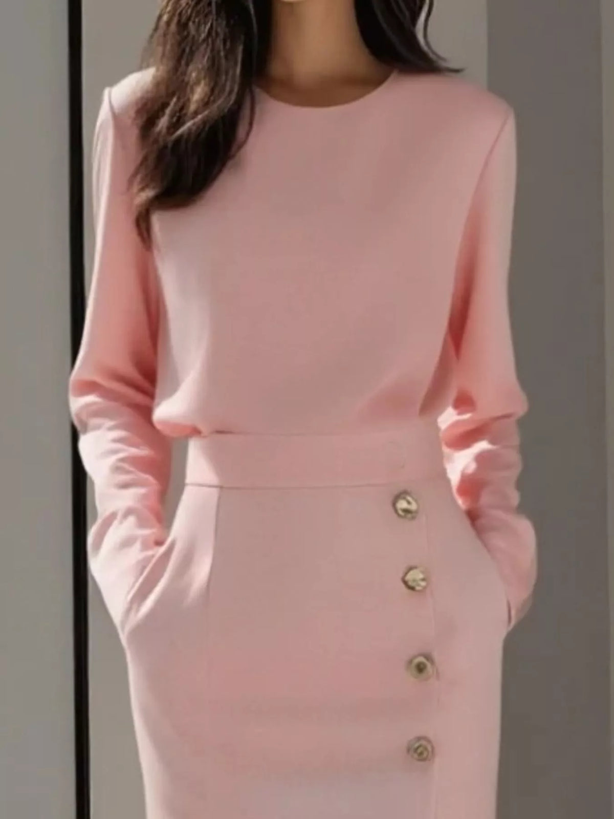 Long Sleeve Button Detail Midi Dress with Side Slit shown in pink with side pockets and button detail.