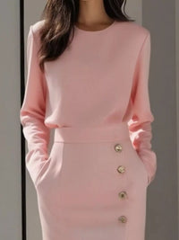 Long Sleeve Button Detail Midi Dress with Side Slit shown in pink with side pockets and button detail.