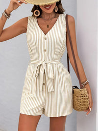 Striped V-neck button front belted romper worn by a woman, featuring a stylish design and practical pockets.