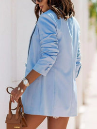 Chic woman wearing a blue lapel collar long sleeve blazer, styled for luxurious weddings and modern sophistication.