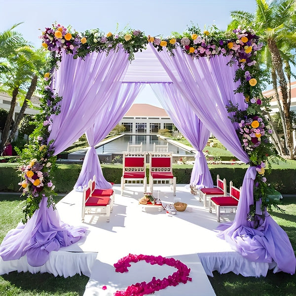 a wedding setup with purple drapes and flowers