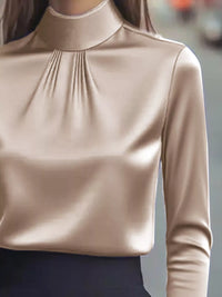 Mock Neck Long Sleeve Blouse with Pleated Detail in a shiny beige fabric, showcasing elegant pleated detailing.