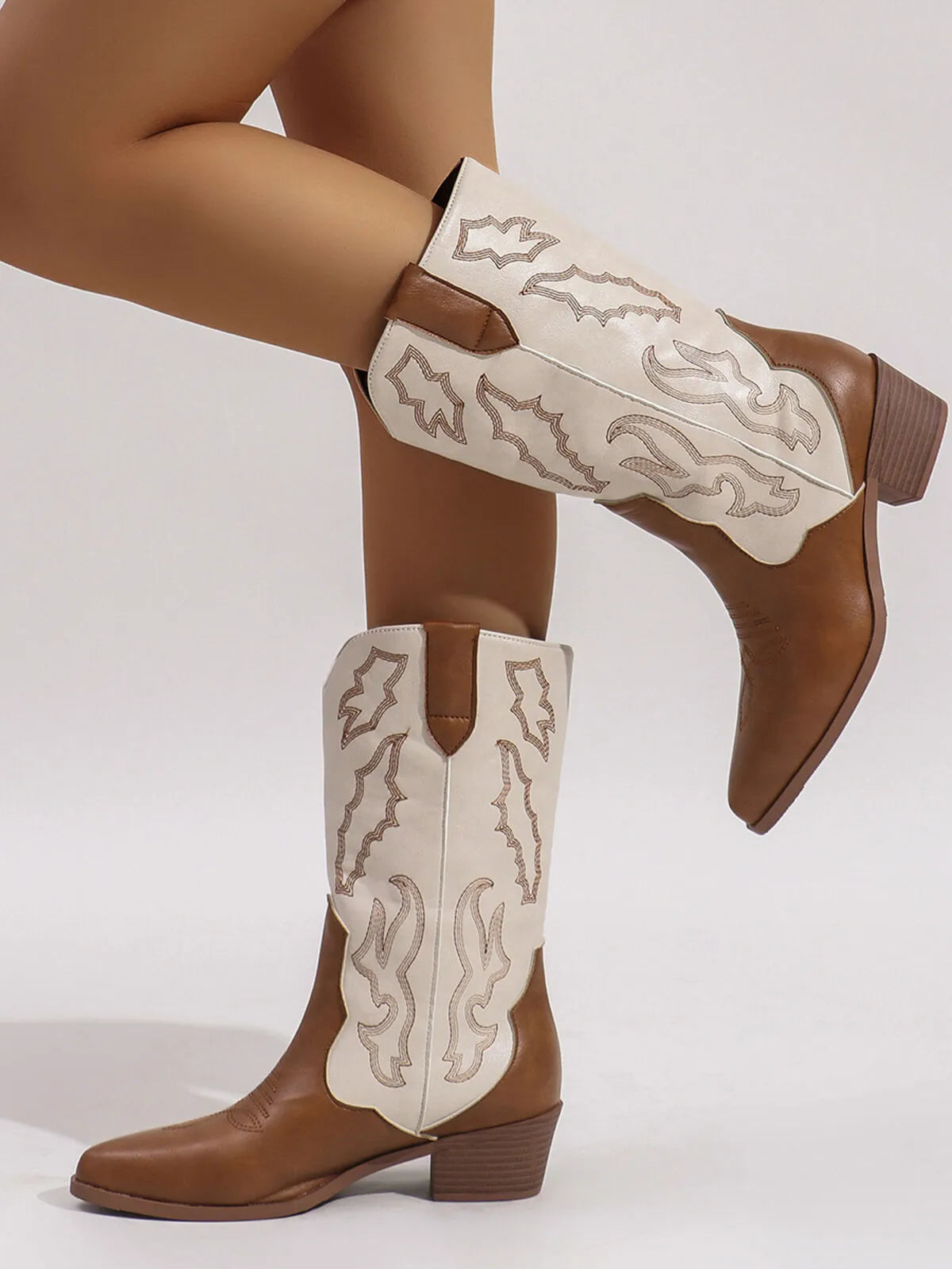 Point toe block heel boots with decorative stitching, featuring a tan and cream color scheme.