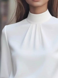 Mock Neck Long Sleeve Blouse with Pleated Detail in white fabric, showcasing pleated design and elegant silhouette.